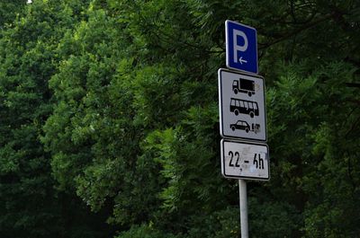 Road sign by trees