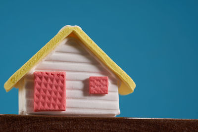 Low angle view of model house against blue sky