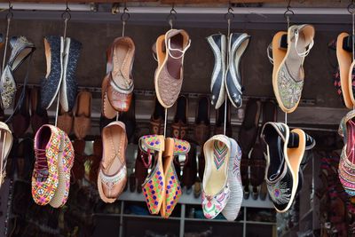 Clothes hanging in row for sale at market