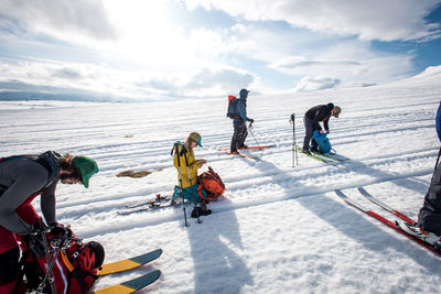 Group of skiers rest on a backcountry ski trip