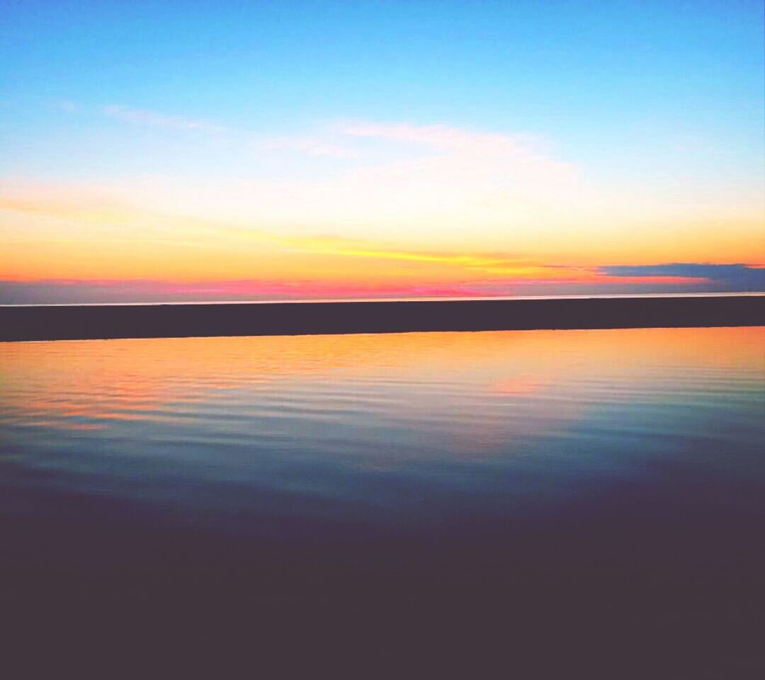 sunset, water, tranquil scene, scenics, tranquility, sea, beauty in nature, sky, horizon over water, beach, nature, idyllic, reflection, orange color, shore, calm, non-urban scene, outdoors, blue, remote