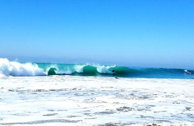 Scenic view of sea against clear blue sky