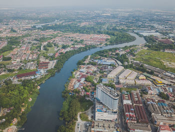 High angle view of river by city against sky