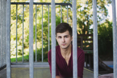 Portrait of young man in cage