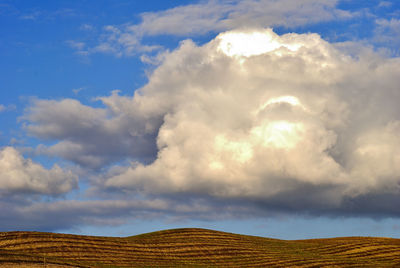 Low angle view of land against cloudy sky