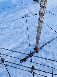 Low angle view of electricity pylon against sky