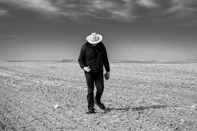 Full length of man standing on field against sky