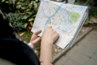 Midsection of woman looking at map