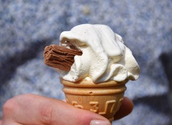 Close-up of hand holding ice cream cone