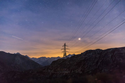 Scenic view of mountains against sky at night