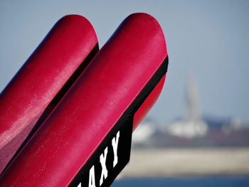 Close-up of red metallic structure against the sky