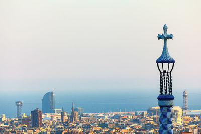 Cross on the spire top over barcelona city . balearic sea coast in barcelona