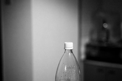 Close-up of bottle on table by window