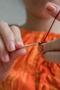 Midsection of woman knitting wool