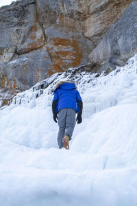 Rear view of person on snowcapped mountain