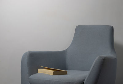 Close-up of books on table against wall