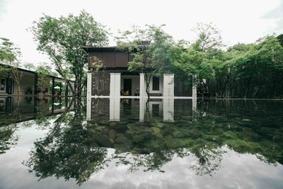 Reflection of building on lake against sky