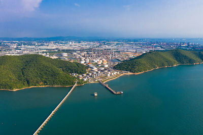 High angle view of cityscape by sea against sky