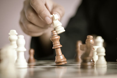 Close-up of hand of chess pieces