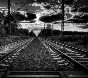 Railroad track against cloudy sky