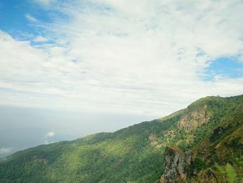 Scenic view of mountains against cloudy sky