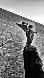 Low angle view of statue against wall