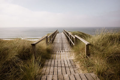 Pier over sea against sky