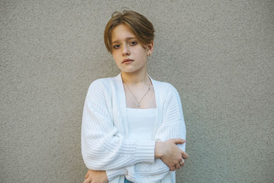 Redhead teenager with stylish short hair presents a bold look, portrait a canvas of exuberance