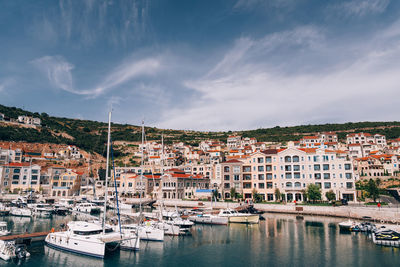 Panoramic view of townscape and harbor against sky