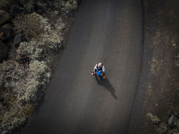 High angle view of man sitting on rock