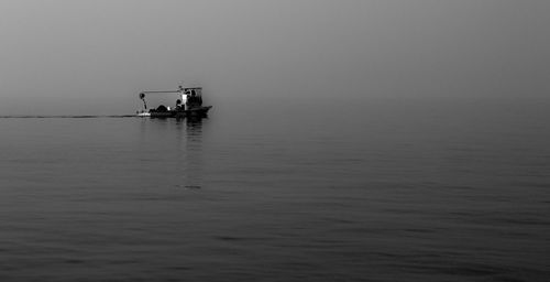 Boat sailing on sea against sky