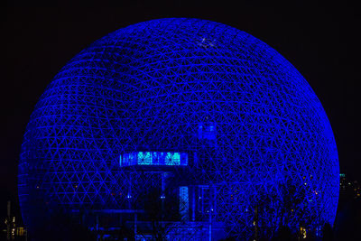 Low angle view of illuminated lights at night