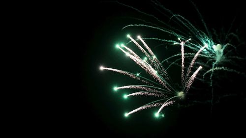 Low angle view of firework display at night