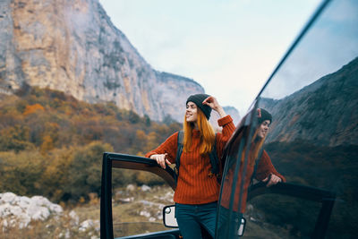 Full length of woman standing on mountain