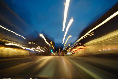 Light trails on road in city at night