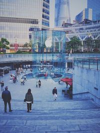 People in city against sky