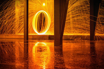 Light painting on lake against sky at night