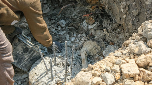 Low section of man standing on rock