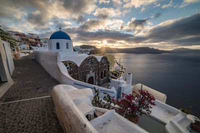 High angle view of buildings by sea against sky