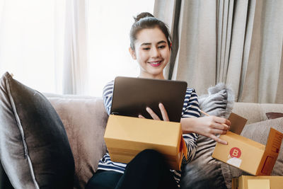 Portrait of woman using laptop at home