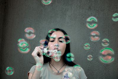 Portrait of a young woman in bubbles