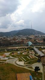 High angle view of buildings against cloudy sky