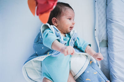 Cute baby girl sitting on sofa