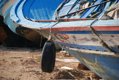 Close-up of abandoned boat on field