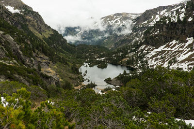 Scenic view of lake amidst mountain during winter