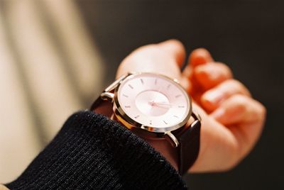 Close-up of hand holding clock