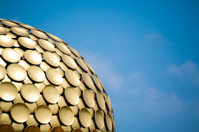 Low angle view of modern building against blue sky