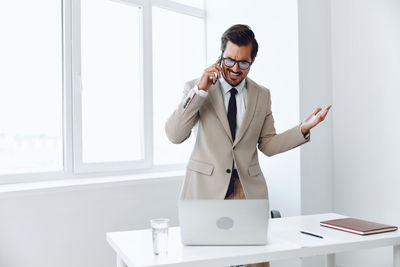 Young woman using mobile phone at office