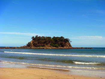 Scenic view of beach against clear sky