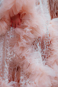 Pastel pink fluffy long haute couture boudoir dress with glitter. fashion details. vertical shot